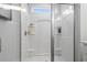 Elegant tiled shower with glass door, built-in shelves, and modern fixtures at 508 Crown Dr, Emerson, GA 30137