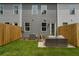 Spacious backyard featuring a patio with comfortable seating, surrounded by a wooden privacy fence at 512 Crown Dr, Emerson, GA 30137