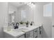 Bathroom featuring dual sinks, a large mirror, and modern fixtures at 512 Crown Dr, Emerson, GA 30137