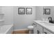 Bathroom featuring a white vanity with modern fixtures, wood flooring, and framed art at 512 Crown Dr, Emerson, GA 30137