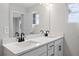 Bright bathroom featuring double sinks, white cabinets, and contemporary fixtures at 512 Crown Dr, Emerson, GA 30137