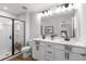 Bright bathroom with a double sink vanity, modern lighting, and a glass enclosed shower at 512 Crown Dr, Emerson, GA 30137
