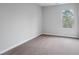Bright bedroom featuring carpet floors, a window bringing in natural light, and neutral walls at 512 Crown Dr, Emerson, GA 30137