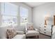 Bright bedroom seating area with two cozy chairs, a window, and storage cabinet at 512 Crown Dr, Emerson, GA 30137