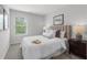 Cozy bedroom featuring a comfortable bed, stylish bedside table, and bright window at 512 Crown Dr, Emerson, GA 30137
