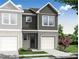 New construction townhome showcasing gray siding, brick accents, and manicured landscaping at 512 Crown Dr, Emerson, GA 30137