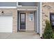 Inviting front entrance with a stylish door, stone accents, and manicured greenery at 512 Crown Dr, Emerson, GA 30137
