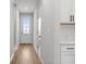 Bright hallway with hardwood floors, white doors and trim, and modern fixtures at 512 Crown Dr, Emerson, GA 30137