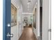 Bright hallway with wood floors, leading to living space and staircase at 512 Crown Dr, Emerson, GA 30137