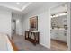 Hallway featuring a decor table and bathroom entrance with double sink vanity at 512 Crown Dr, Emerson, GA 30137
