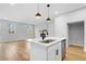 Open-concept kitchen with island, stainless steel appliances, and hardwood floors, blending into the living space at 512 Crown Dr, Emerson, GA 30137