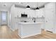 Open concept kitchen with island, stainless steel appliances, and light wood flooring at 512 Crown Dr, Emerson, GA 30137