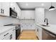 Modern kitchen featuring white cabinets, quartz countertops, and stainless steel appliances at 512 Crown Dr, Emerson, GA 30137