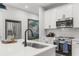 Stylish kitchen featuring white cabinets, stainless steel appliances, and a modern faucet at 512 Crown Dr, Emerson, GA 30137