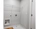 Utility room with wood-look floors, neutral walls, washer and dryer hookups, and a door at 512 Crown Dr, Emerson, GA 30137