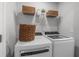 Laundry room boasts modern washer and dryer with overhead storage and baskets at 512 Crown Dr, Emerson, GA 30137