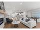 Sunlit living room with an open concept featuring a fireplace and a modern kitchen at 512 Crown Dr, Emerson, GA 30137