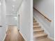 Hallway and staircase with neutral carpeting, leading to the upper level of the home at 512 Crown Dr, Emerson, GA 30137