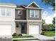 New two-story townhome features a stone and gray facade, a single-car garage, and lush landscaping at 514 Crown Dr, Emerson, GA 30137