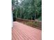 Large wooden deck offering outdoor living space, railing, and backyard view at 8130 Estee Dr, Cumming, GA 30028