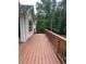 Spacious wooden deck features railing, an entrance to the home, and backyard views at 8130 Estee Dr, Cumming, GA 30028