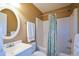 Cozy bathroom featuring a shower with a patterned shower curtain, toilet, and oval mirror at 8130 Estee Dr, Cumming, GA 30028