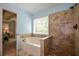 Bathroom featuring a tub and shower combination with decorative tile surround at 8130 Estee Dr, Cumming, GA 30028