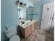 Bathroom with double sink vanity and large mirror with modern lighting at 8130 Estee Dr, Cumming, GA 30028