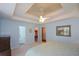Bedroom with tray ceiling; featuring large bed and access to closet at 8130 Estee Dr, Cumming, GA 30028
