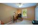 Bedroom with tan carpet, window view, and a ceiling fan at 8130 Estee Dr, Cumming, GA 30028