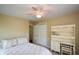 Bright bedroom with neutral walls, a bed, and a desk, creating a peaceful retreat at 8130 Estee Dr, Cumming, GA 30028