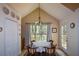 Charming dining area featuring a round table and chairs, chandelier lighting, and a large window with nature views at 8130 Estee Dr, Cumming, GA 30028