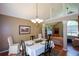 Formal dining room with wood floors and vaulted ceilings, adjacent to living area at 8130 Estee Dr, Cumming, GA 30028