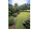 Lush front yard featuring a large manicured lawn and mature landscaping with flowering shrubs at 8130 Estee Dr, Cumming, GA 30028