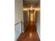 Hallway with hardwood floors, neutral walls, and overhead lighting leading to rooms and bathroom at 8130 Estee Dr, Cumming, GA 30028
