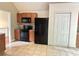 Spacious kitchen featuring tile floors, wood cabinets, a black refrigerator, and modern appliances at 8130 Estee Dr, Cumming, GA 30028
