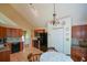 Well-lit kitchen features tile floors, modern appliances, cabinets, and a quaint dining area with a floral tablecloth at 8130 Estee Dr, Cumming, GA 30028