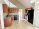 Functional kitchen featuring wood cabinets, granite countertops, and black appliances at 8130 Estee Dr, Cumming, GA 30028