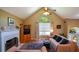 Cozy living room with a fireplace, large window, and comfortable seating at 8130 Estee Dr, Cumming, GA 30028