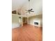 Bright living room featuring a fireplace, wood floors, and high ceilings at 8130 Estee Dr, Cumming, GA 30028