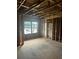 Unfinished bedroom features window with view of street, and exposed framing ready for drywall and carpeting at 1163 Park Center Cir, Austell, GA 30168