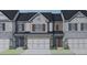 Charming townhome featuring a blend of brick and stone facade with a two-car garage and inviting entrance at 1163 Park Center Cir, Austell, GA 30168