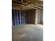 Unfinished living room featuring exposed beam ceiling, bare insulation, and an unfinished subfloor at 1163 Park Center Cir, Austell, GA 30168