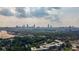 This aerial shot showcases the city skyline surrounded by a lush tree canopy and condominiums at 1272 Hardee Ne St, Atlanta, GA 30307