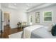 Airy bedroom boasts tray ceiling, hardwood floors, and access to outdoor space, blending comfort with sophistication at 1272 Hardee Ne St, Atlanta, GA 30307