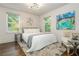 This bedroom features hardwood floors, two windows and a queen sized bed with white linens at 1272 Hardee Ne St, Atlanta, GA 30307