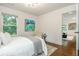 This bedroom features a window and doorway to the next room. An art piece hangs on the wall at 1272 Hardee Ne St, Atlanta, GA 30307