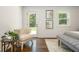 Bedroom featuring elegant chair, hardwood floors, and a sunlit ambiance, perfect for relaxation and style at 1272 Hardee Ne St, Atlanta, GA 30307