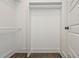 Inside this closet is a hanger bar with a wooden floor and painted white walls at 1272 Hardee Ne St, Atlanta, GA 30307
