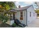 Charming white brick home featuring a covered porch, landscaped yard, and modern architectural details at 1272 Hardee Ne St, Atlanta, GA 30307